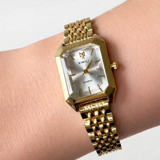Gold rectangular quartz watch worn on wrist