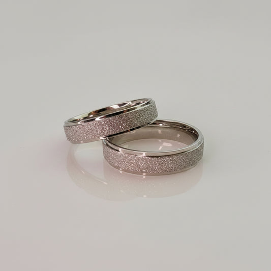 Two silver stardust rings showing different sizes